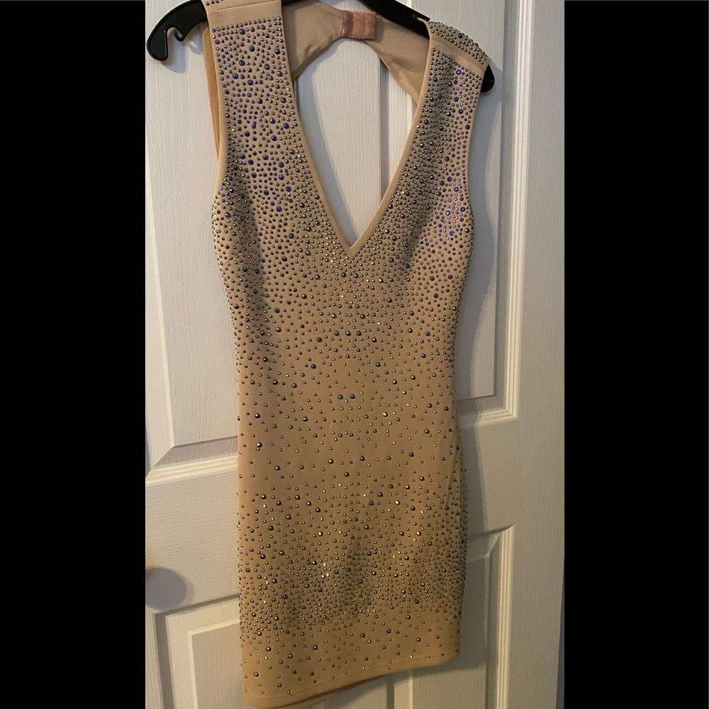 Nude short dress with iridescent beading.